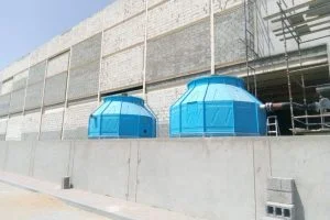 "Cooling towers installed near a building wall.